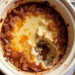 Creamy crockpot dip featuring caramelized onions and melted Gruyere cheese for a savory snack experience.
